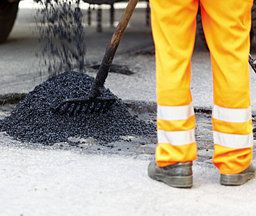 Preventing and repairing potholes and pavement cracks